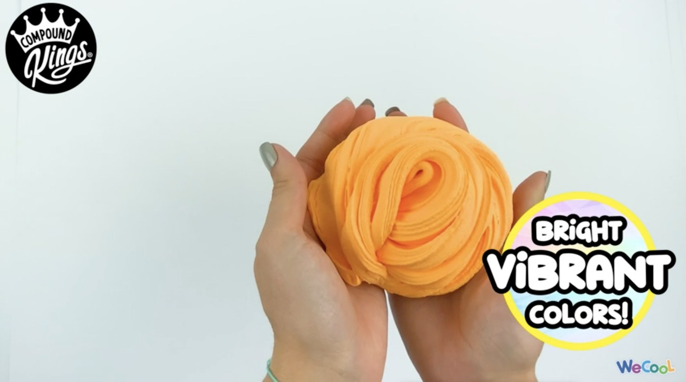 Children stretching bright Compound Kings butter slime between their hands